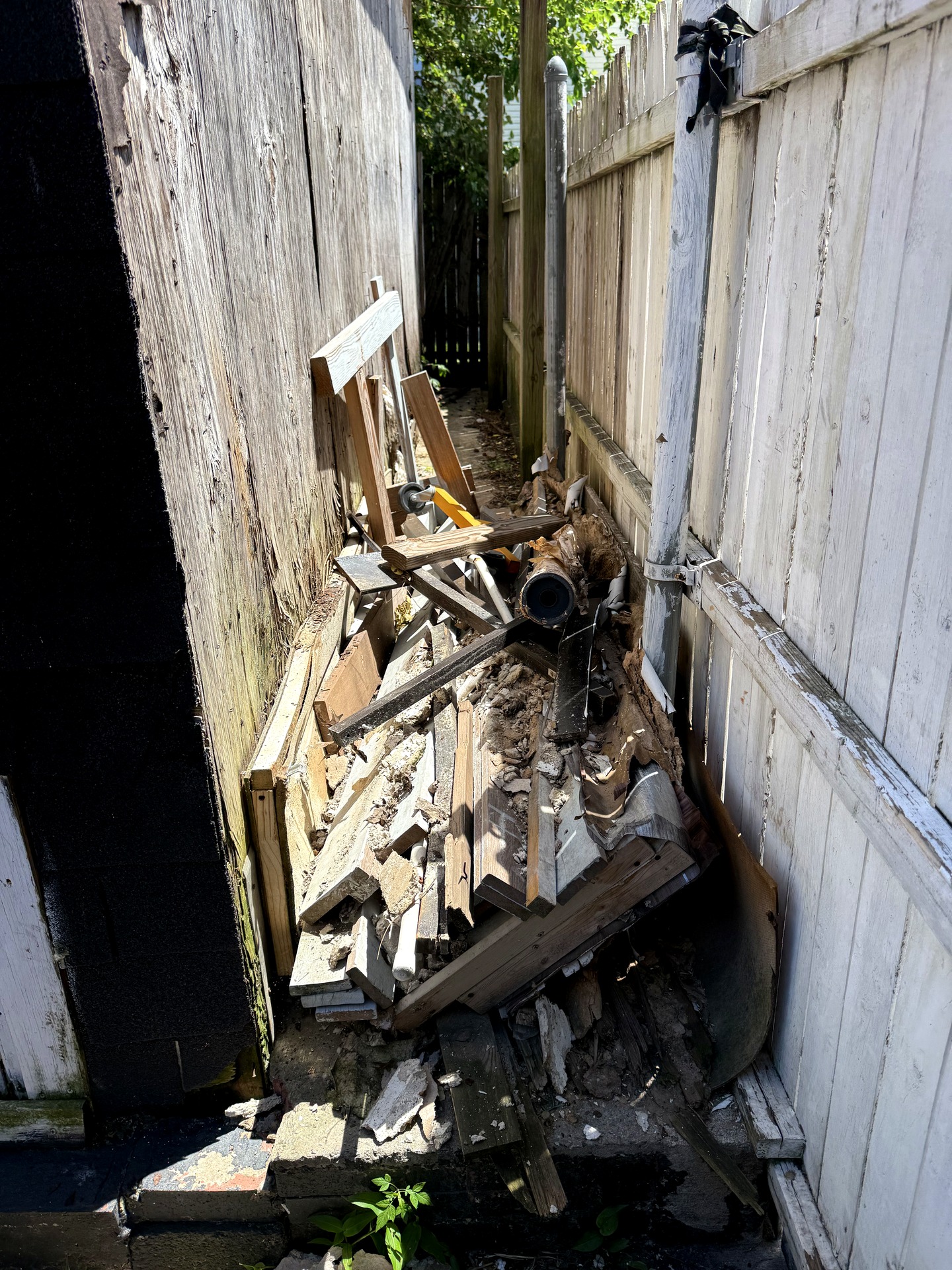 Before yard and debris cleanout in Wayne, NJ — cluttered backyard filled with brush, junk, and debris before Ghost Junk Management removal