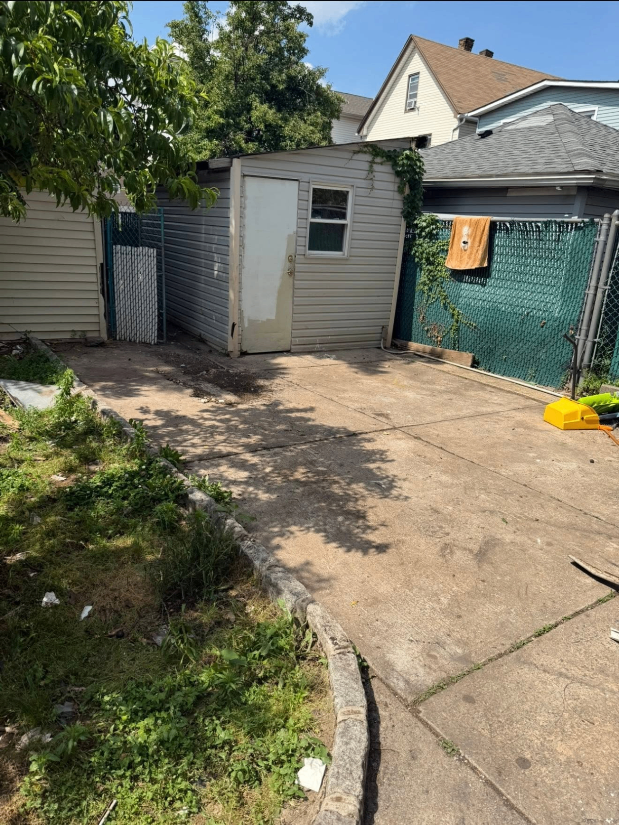 After driveway junk removal by Ghost Junk Management — spotless driveway with all junk, boxes, and debris hauled away same day